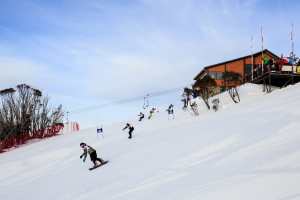 Snowboarders hitting the Supertrail after the big Kareela turn.