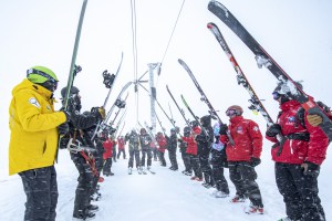 Mt Buller ski patrol make a guard of honour for the final ride up the Boggy Creek T bar by retired patrollers Donny Morgan and Brian Singer. BSL General Manager Laurie Blampied (L) in yellow and Ski Patrol Manager Sam MacDougall (R) topped the honour guard line in freshly falling snow at 5pm on Sunday 8 September Pic: Tony Harrington
