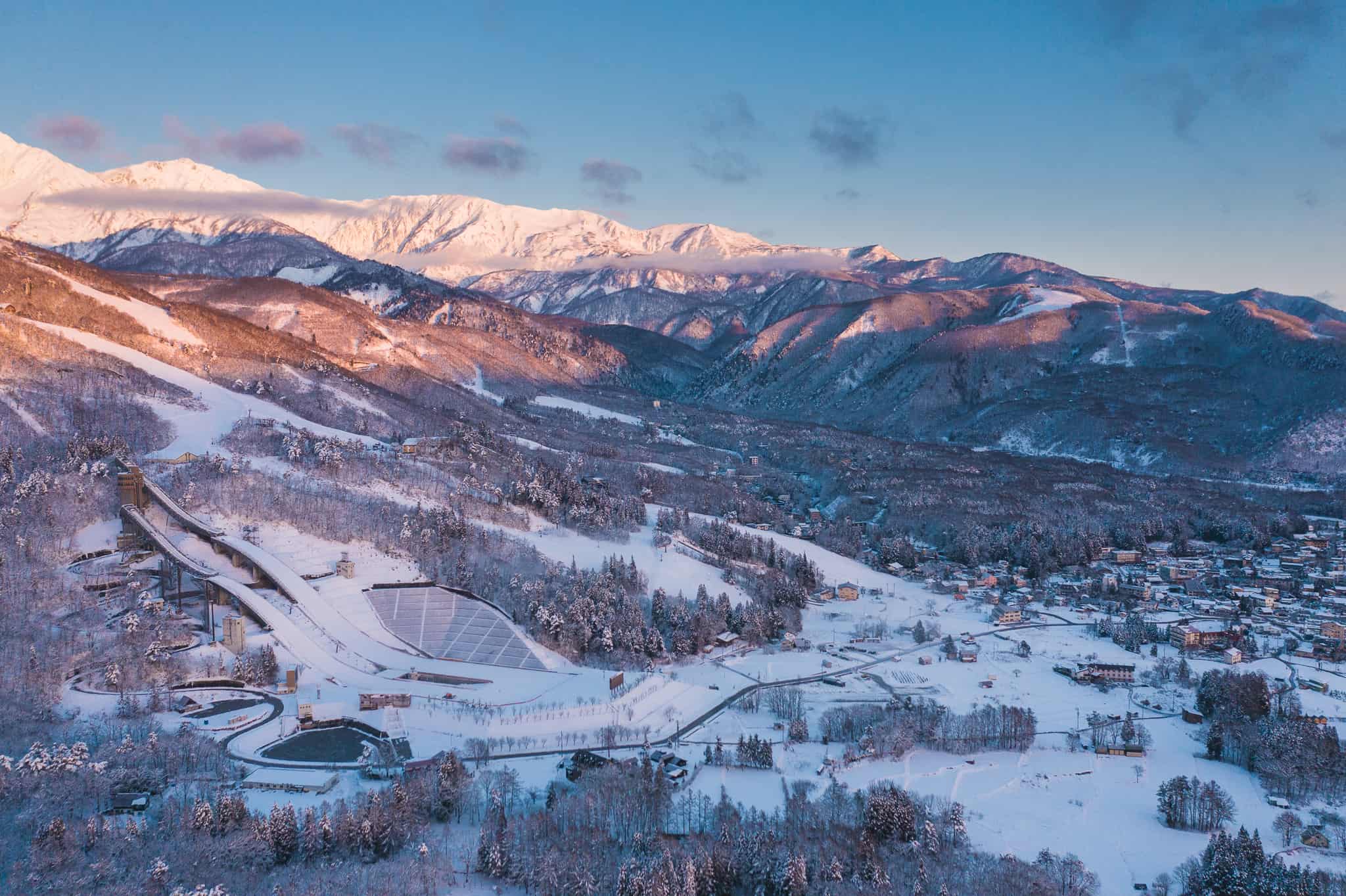 Sunrise over the mountains in Hakuba, the ski jumps built for the Nagano Olympics to the left.
