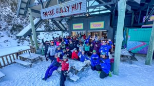 Skiers and snowboarders gather at Snake Gully Hut, where $1 from every coffee sold was matched by Vail Resorts through the Epic Promise Foundation, and donated to the White Ribbon Foundation. Photo: Hotham