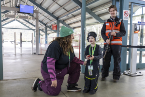 Hidden Disabilities Sunflower Program participant Rachelle Edwards, with her son,  at the Perisher Skitube